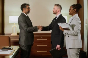 Two professionals sealing a franchise deal with a handshake after negotiations.